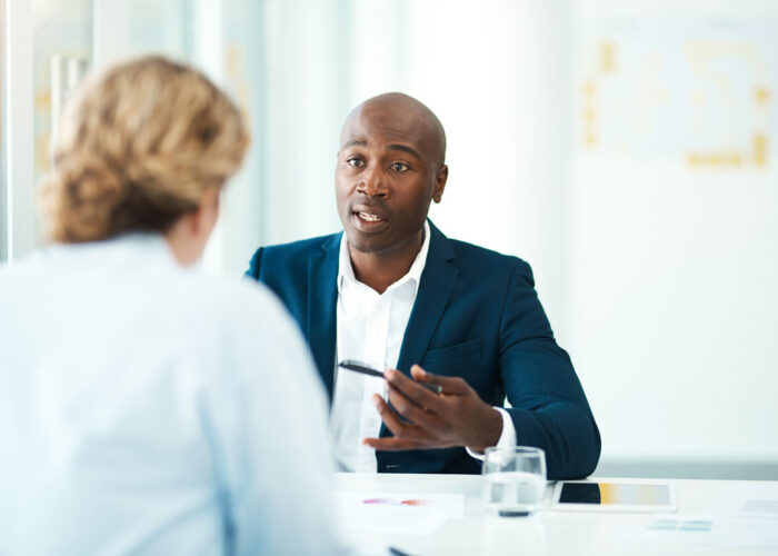 African American Man in business meeting talking